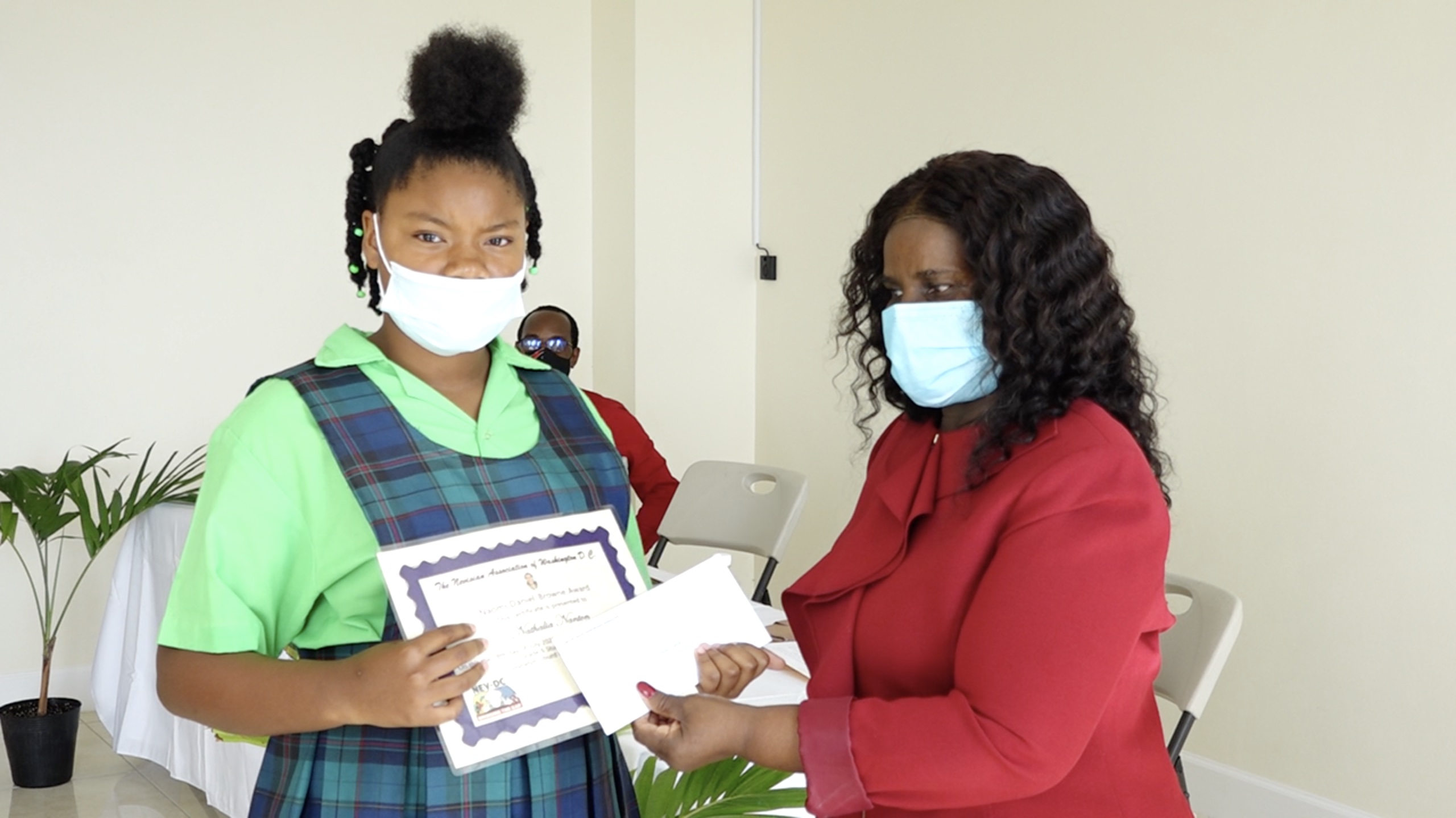 Nathalia Nanton of the Joycelyn Liburd Primary School receives Naomi Daniel-Browne Scholarship Award from Mrs. Adina Taylor, sister of the late Naomi Daniel-Browne