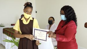 Kailar Isaac of the St. Thomas’ Primary School receives Naomi Daniel-Browne scholarship award from Mrs. Adina Taylor, sister of the late Naomi Daniel-Browne