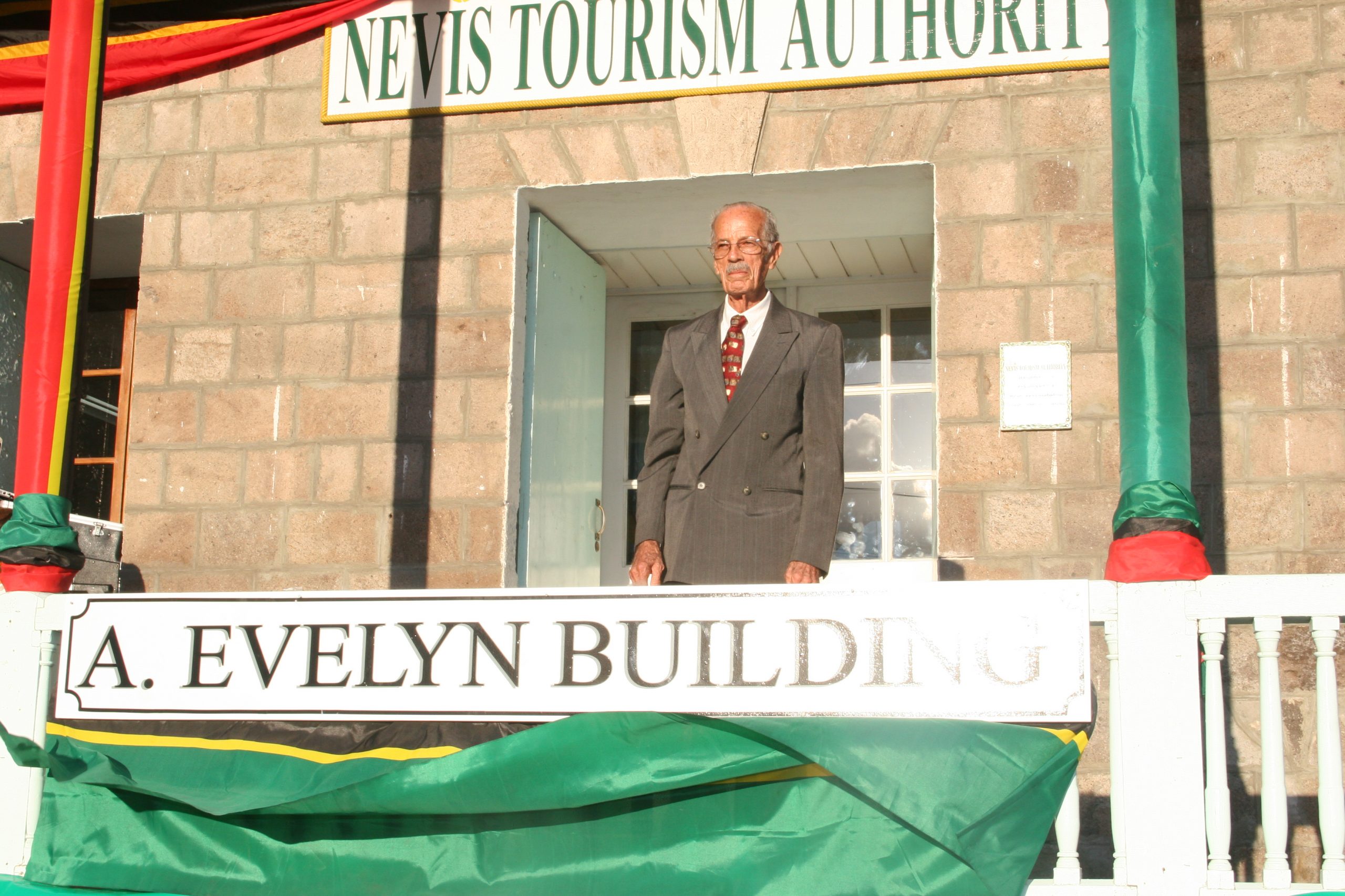 The late Mr. Arthur Evelyn, the First Minister of Tourism on Nevis, moments after unveiling the new name of the Old Treasury Building in Charlestown in 2010 renamed in his honour by the Nevis Island Administration