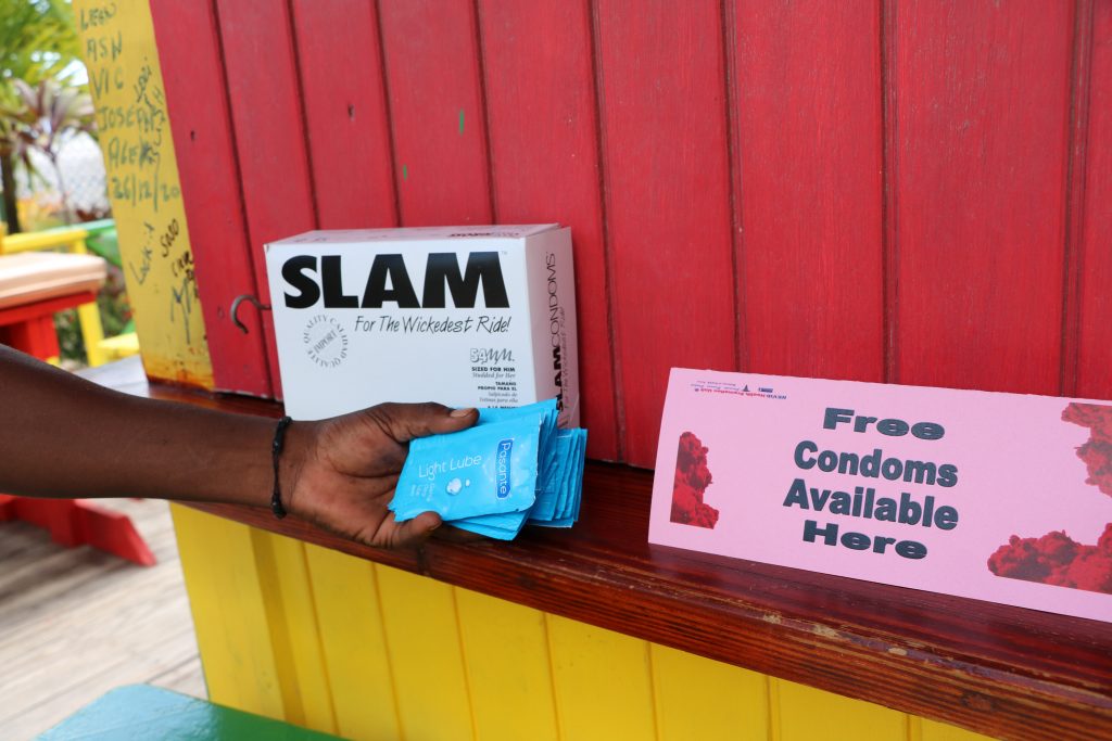 A sign indicating the availibity of free condoms along with condoms and packets of lubricant delivered to Sunshine’s Beach Bar and Grill on August 04, 2021, by the Nevis Health Promotion Unit as part of its initiative to promote condom use to fight against HIV and other sexually transmitted infections