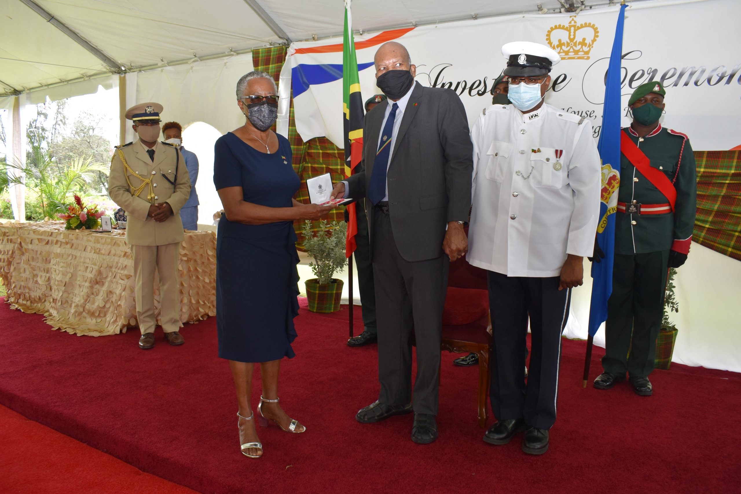 Sir Tapley Seaton, Governor General and representative of Queen Elizabeth II in the Federation, presents Her Honour Mrs. Hyleeta Miranda Liburd, Deputy Governor General for Nevis with the award of the Most Excellent Order of the British Empire (OBE) for her contribution to public service at an Investiture Ceremony at Government House in St. Kitts on August 19, 2021