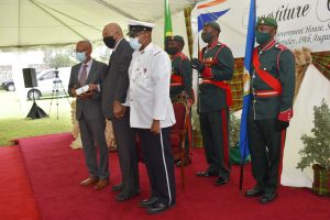 Sir Tapley Seaton, Governor General and representative of Queen Elizabeth II in the Federation, presents Mr. Colin D.A Tyrell, with the Most Excellent Order of the British Empire (MBE) for his contribution to community service at an Investiture Ceremony at Government House in St. Kitts on August 19, 2021