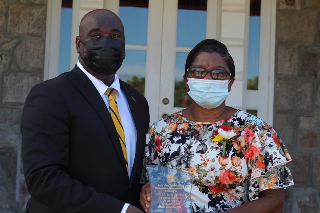 Ms. Christiana Smith from Fountain Village with Hon. Alexis Jeffers, Area Representative for St. James' Parish, showing off the award she received for Community Service on the occasion of the 38th Anniversary of Independence of St. Christopher and Nevis at an awards ceremony at Government House on September 20, 2021