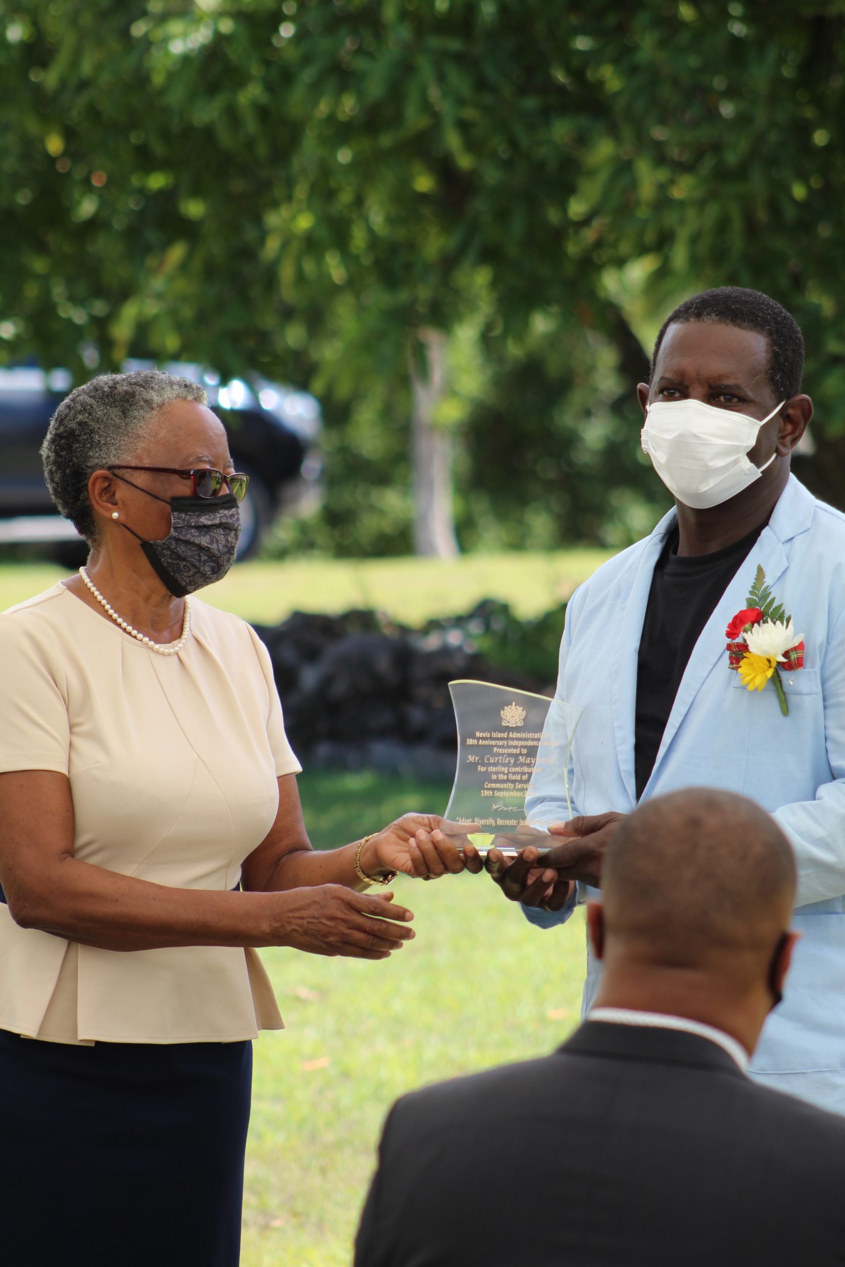 Mr. Curtley Maynard of Gingerland receiving a plaque from Her Honour Mrs Hyleeta Liburd for his contribution to the development of Music at an Awards Ceremony on September 20, 2021, at an Awards Ceremony at Government House on the occasion of the 38th Anniversary of Independence of St. Christopher and Nevis