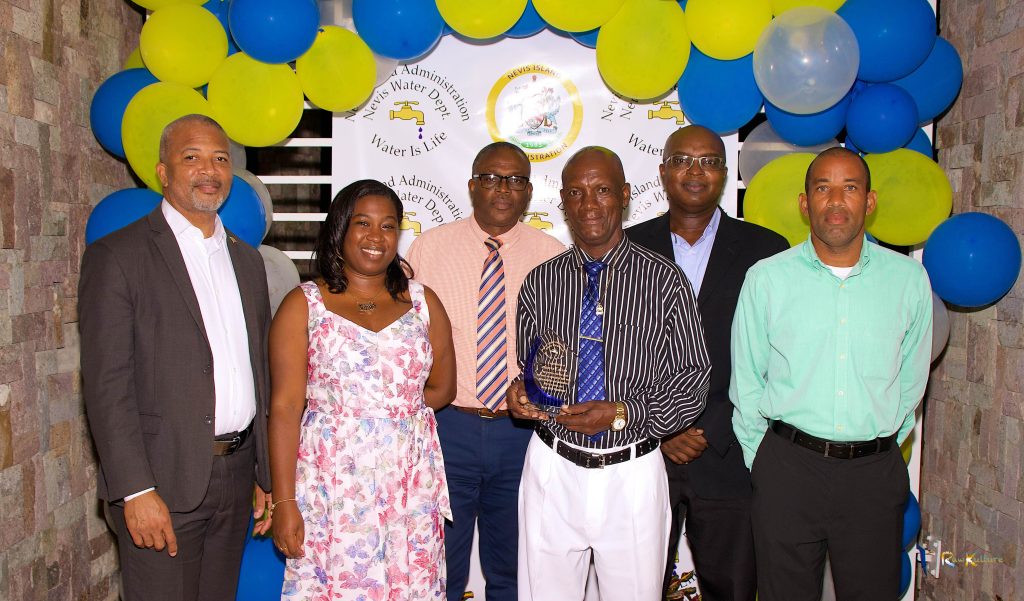 Photo caption: (L-r) Hon. Spencer Brand, Minister of Water Services on Nevis; Ms. Tonya Bartlette, Manager of the Nevis Water Department; Mr. Denzil Stanley, Principal Assistant Secretary in the Ministry of Water Services; Mr. James “Tin Tin” Caines, the longest serving of three retirees honoured by the Nevis Water Department; Dr. Ernie Stapleton, Permanent Secretary in the Ministry of Water Services and Mr. Roger Hanley, Operation Manager at the Nevis Water Department at a Retiree Cocktail celebration at the Nevis Performing Arts Centre on September 30, 2021