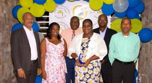 (L-r) Hon. Spencer Brand, Minister of Water Services on Nevis; Ms. Tonya Bartlette, Manager of the Nevis Water Department; Mr. Denzil Stanley, Principal Assistant Secretary in the Ministry of Water Services; Ms. Roslyn Mills, daughter of retiree Mr. Carlton “Cherry” Williams who accepted an award on her father’s behalf on his retirement from the Nevis Water Department; Dr. Ernie Stapleton, Permanent Secretary in the Ministry of Water Services and Mr. Roger Hanley, Operation Manager at the Nevis Water Department at a Retirement Cocktail celebration at the Nevis Performing Arts Centre on September 30, 2021
