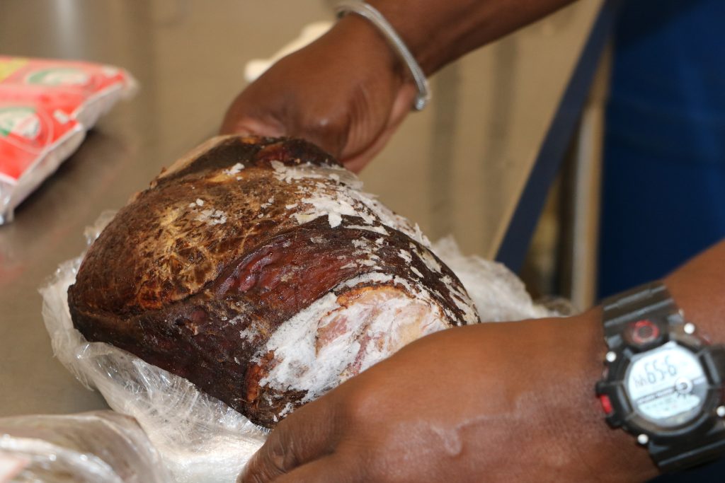 Unwrapping a frozen local smoked at the Abattoir Division in the Department of Agriculture on Nevis on November 11, 2021