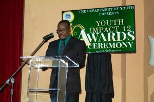 Mr. Keith Glasgow, Permanent Secretary in the Ministry of Youth, delivers remarks at the Department of Youth’s annual Youth Impact 12 Awards Ceremony at the Nevis Performing Arts Centre on November 04, 2021