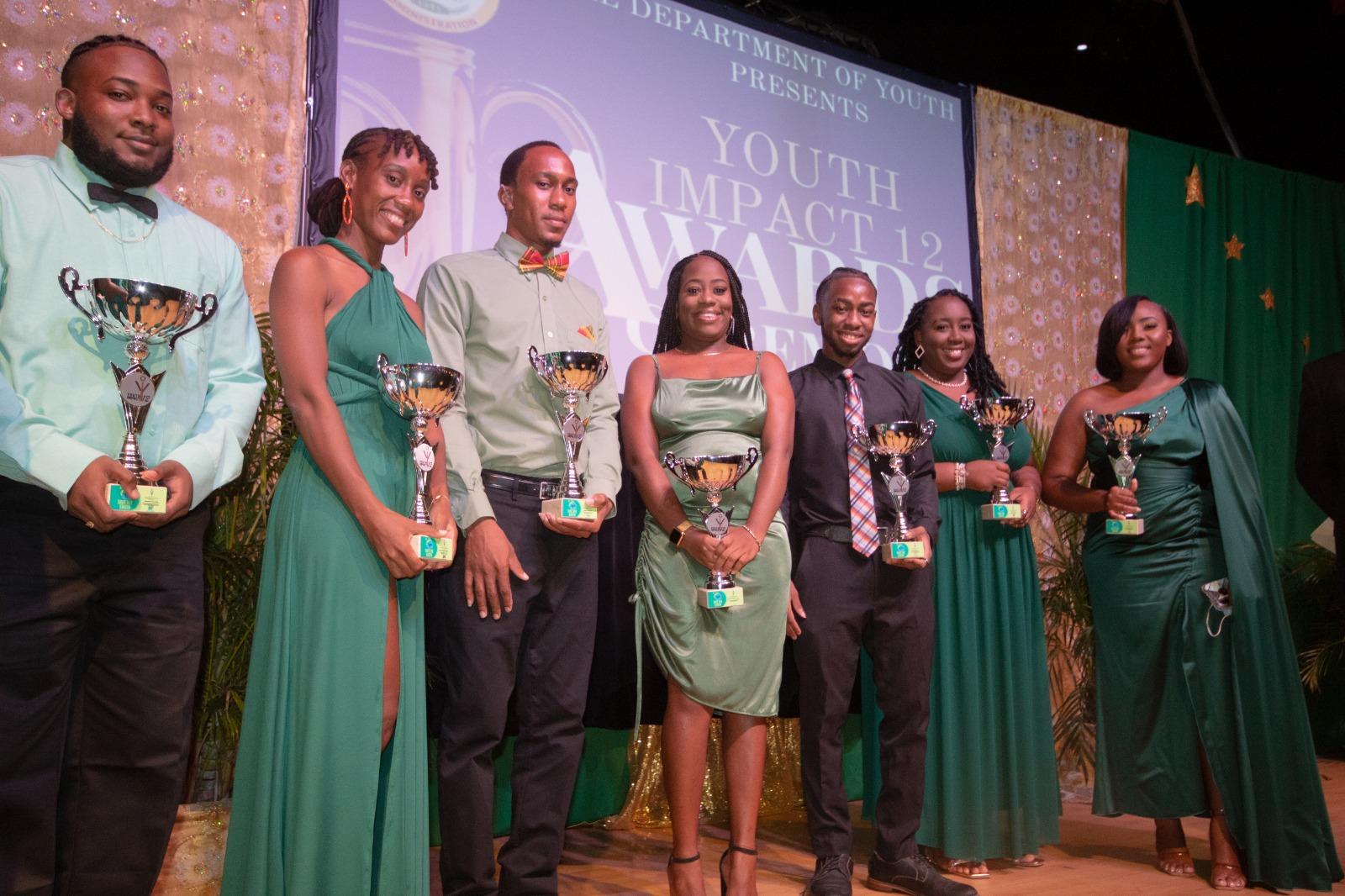 Seven of the nine awardees present at the Youth Impact 12 Awards Ceremony at the Nevis Performing Arts Centre on November 04, 2021 (l-r) Brendon Claxton for Education and Lifelong Learning; Mervil Jahnel Nisbett for Patriotism; Shakir Stapleton for Youth Development; Yahsulazie Flanders-Grant for Entrepreneurship; Davien Griffin for Youth in the Arts; Maliqua Kamau for Volunteerism; and Diandra Archibald for Volunteerism.