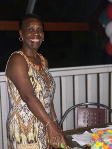 Ms. Yvette Jackman of the Nevis Tourism Authority about to cut her retirement cake at a surprise retirement cocktail hosted in her honour on December 20, 2021, by the Nevis Tourism Authority at the Ole House Café in Charlestown