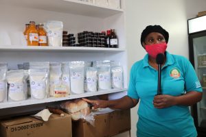 Mrs. Shermel England, Manager of the Nevis Agro Processing Centre at Prospect showing some products made there
