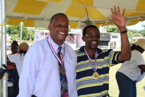 (l-r) Hon. Eric Evelyn, Minister of Culture, Youth, Sports, and Community Development enjoying a moment at a sporting event for seniors some years ago at the Elquemedo T. Willett Park in Charlestown (file photo)