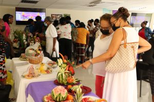 Mrs. Sharon Brantley, wife of Hon. Mark Brantley, Premier of Nevis, viewing products in the fruit and vegetable carving participants on display at the Department of Gender Affairs’ Gender Expo ‘22 at the Malcolm Guishard Recreational Grounds at Pinney’s on March 18, 2022