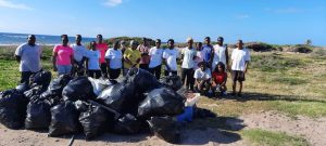 Volunteers with garbage collected in the St. George's Parish in February during a month-long clean-up exercise funded and organised by (extreme right) Hon. Eric Evelyn, Area Representative
