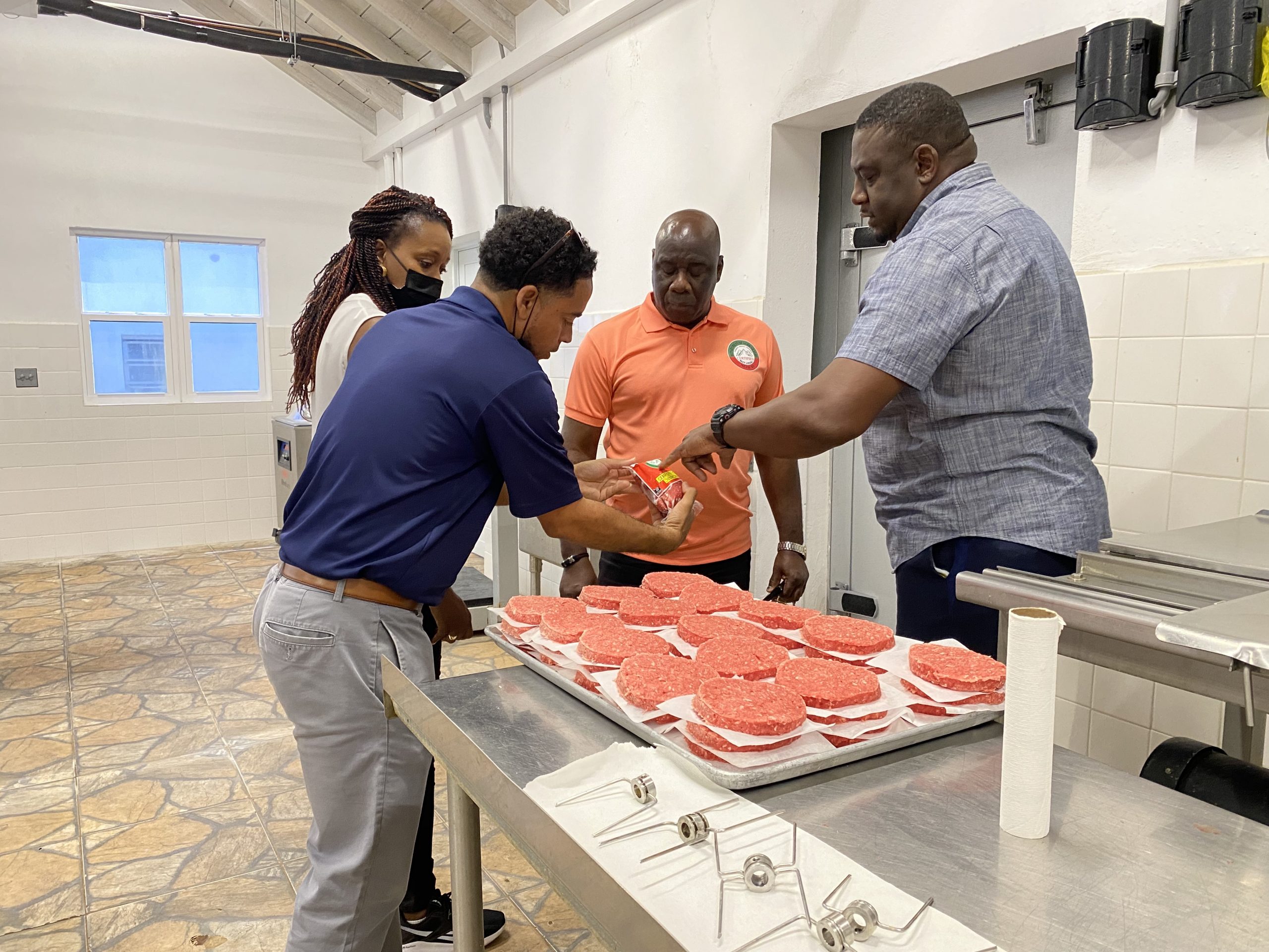 (L-r) Visiting officials to Nevis from Anguilla Hon. Kyle Hodge, Minister of Economic Development, Natural Resources and Information Technology; and Ms. Melissa Meade, Chief Natural Resources Officer in the Department of Natural Resources; looking at local beef products at the Abattoir Division with Hon. Alexis Jeffers, Deputy Premier of Nevis and Minister of Agriculture; and Mr. Garfield Griffin, Manager of the Nevis Abattoir and Meat Processing Plant at the Department of Agriculture on April 27, 2022