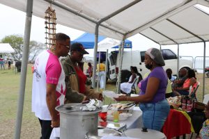 A vendor at the Bath Community Festival at Fort Charles on May 07, 2022, serving members of the public including Hon. Mark Brantley, Premier of Nevis, Minister of Tourism and area Representative for Bath Village
