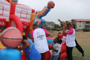 Hon. Eric Evelyn, Minister of Social Development, Youth and Sports (second from left) and Hon. Mark Brantley, Premier of Nevis, Minister of Tourism and area Representative for Bath Village having fun with children at the Bath Community Festival at Fort Charles on May 07, 2022