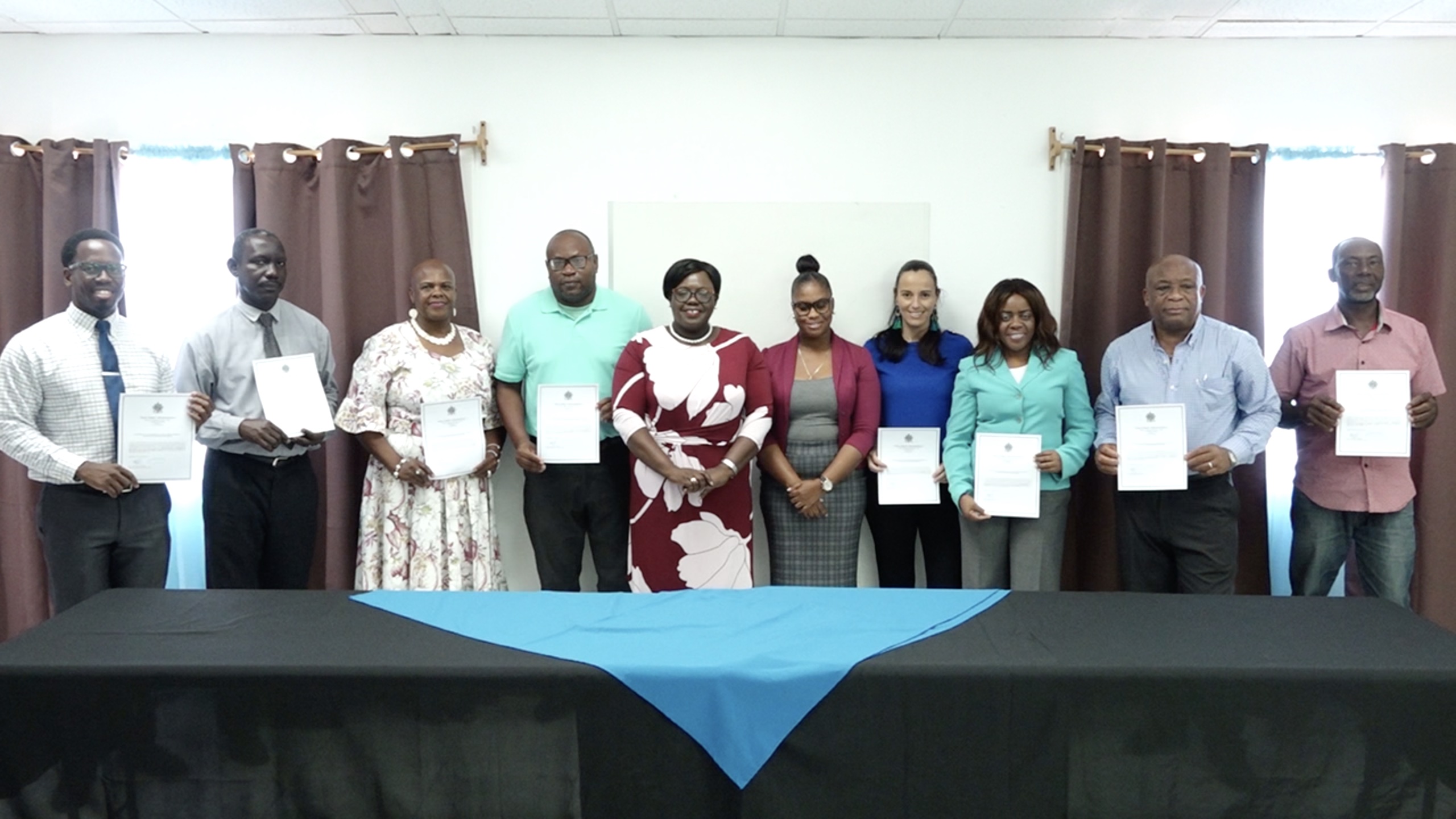 Hon. Hazel Brandy-Williams, Junior Minister of Health and Gender Affairs fifth from left, and Ms. Latoya Jeffers, Assistant Secretary in the ministry (fifth from right; sharing a light moment with the eight newly installed members to serve on the Advisory Board for the Nevis Mentorship Programme from May 19, 2022, (l-r) Mr. Mario Phillip, Gender Officer in the Department of Gender Affairs; Mr. John Hanley, Permanent Secretary in the Ministry of Tourism; Ms. Agnola Hendrickson from the Bank of Nevis International; Mr. Jamir Claxton, Director of Sports; Ms. Joy Napier, Principal of the Nevis International Secondary School; Ms. Jasmine Browne, Counsellor; Mr. Hensley Daniel; and Mr. Alexis Browne