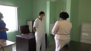 Mr. Ernesto Bruzo, Registered Nurse (Psychiatric Services) and Mrs. Stephanie Rowe-Woodstock, Nursing Attendant at the Mental Health Unit at Prospect showing Hon. Hazel Brandy-Williams the Nurses Station during a walk-through of the facility on June 14, 2022