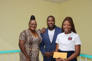 Mr. Eustace Theo Wallace of Hamilton, Minister-Counselor at the St. Kitts and Nevis High Commission to Canada; and his mother Mrs. Hyacinth Wallace-Forbes moments after presenting Ms. Shadé Bridgeman, a student of the Charlestown Secondary School with a Wallace Family Bursary at a handing over ceremony at the Department of Education on August 30, 2022