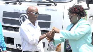 Hon. Hazel Brandy-Williams, Junior Minister of Health, hands over keys to new equipment donated by the Nevis Island Administration on September 08, 2022, to Mr. St. Clair Wallace, Chairman of the Nevis Solid Waste Management Authority’s Board of Directors, for use at the landfill at Long Point  