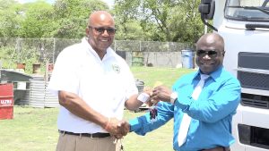 Mr. Andrew Hendrickson, General Manager of the Nevis Solid Waste Management Authority, hands over keys to new equipment donated by the Nevis Island Administration on September 08, 2022, to (right) Mr. Rudy Browne the Authority’s Operations Manager, for use at the landfill at Long Point