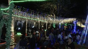 Patrons enjoying the festive atmosphere at the Department of Community Development’s annual Christmas Tree Lighting Ceremony at the War Memorial in Charlestown with a plaque of appreciation on December 07, 2022