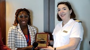 (L-r) Ms. Kelsia Liburd, Marketing Officer at the Nevis Air and Sea Ports Authority and Ms. Elizabeth Vogel, Hotel Director of the Azamara Onward cruise ship exchanging plaques at the welcoming ceremony to mark the ship’s inaugural call to Nevis on January 09, 2023