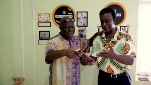 Mr. Stevenson Manners, local author and publisher of the book “The Father Son and Offsprings” presenting a copy of his book to Mr. Elquemedo Tonito Willett, who in 1973 the first Nevisian and Leeward Islander to play test cricket is featured in the publication recently at a recent exhibition at the Nevis Public Library in Charlestown