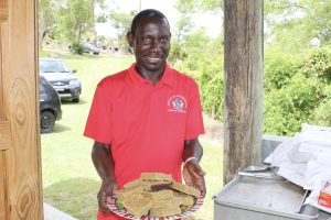 Mr. John Hanley, Permanent Secretary in the Ministry of Tourism with traditional bread pudding during a Heritage Day activity at the Nevisian Heritage Village in Fothergills at Gingerland (file photo)