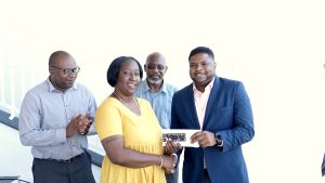 (Front row) Ms. Sharlene Martin, Vice President of the Nevis Cricket Association, presents tickets to Minister of Sports Hon. Troy Liburd for a gala to be hosted by the association on March 09, 2023, in honour of Mr. Elquemedo Tonito Willett while (back row) Mr. Jamir Claxton, Director of the Department of Sports; and Mr. Carlisle Powell, President of the association look on at a handing over ceremony at the Elquemedo T. Willett Park in Charlestown on March 01, 2023