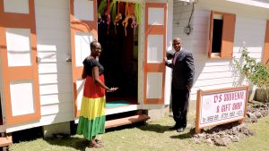 Hon. Eric Evelyn, Deputy Premier of Nevis and Area Representative, cuts the ribbon to officially open D’s Souvenirs and Gift Shop at 20th anniversary celebrations of the Nevisian Heritage Village on March 03, 2023 with the proprietor Ms. Denver Jones Skakur