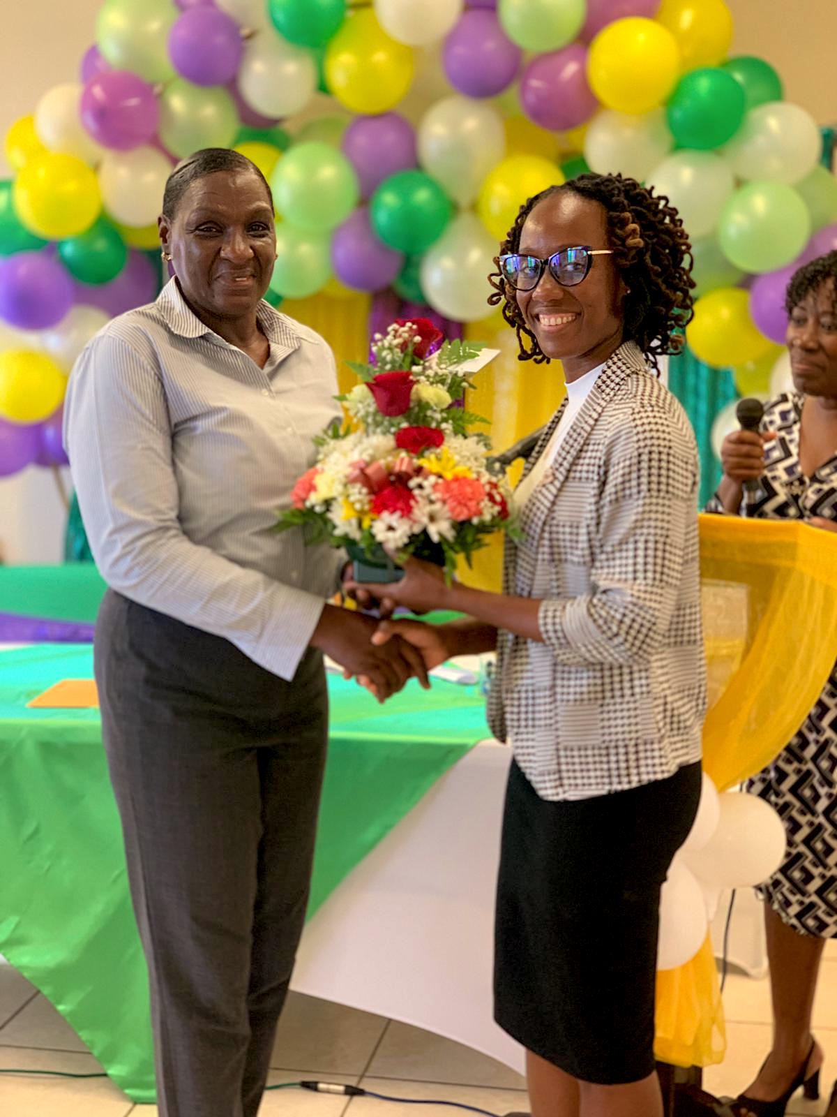 Hon. Jahnel Nisbett, Minister with responsibility for Community Development presenting Mrs. Lydia Claxton at a retirement gathering hosted by the Department of Community Development on Nevis on April 27, 2023, at the Barnes Ghaut Community Centre