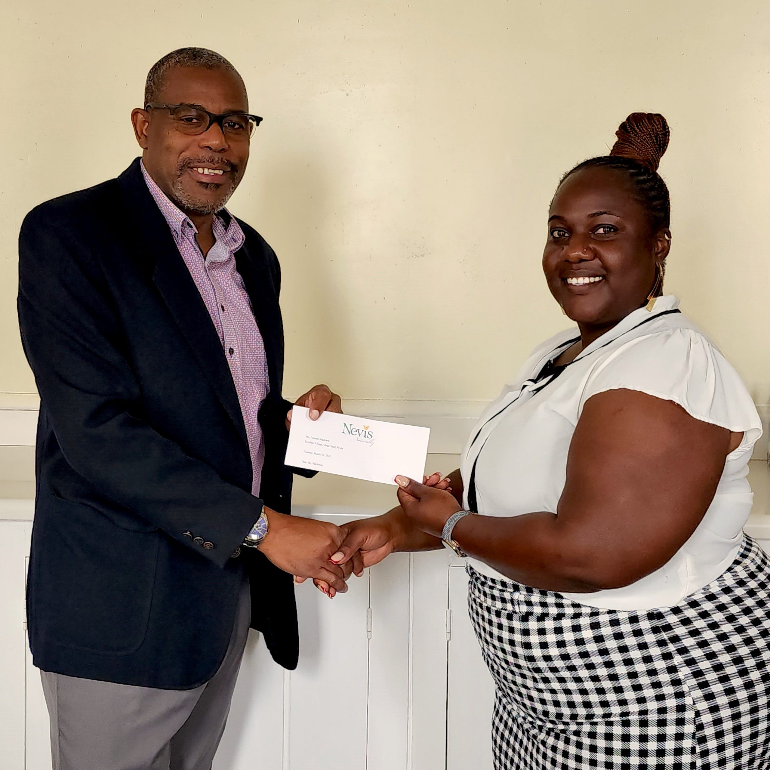 Mr. Devon Liburd, presents scholarship to Chef Berecia Stapleton of Gingerland, winner of the Nevis Tourism Authority NICHE Culinary Scholarship for study in Plant-Based Culinary Arts at the Le Cordon Bleu London