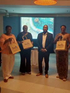Mr. Alexis Arthurton, Caribbean Sales Manager at the Nevis Tourism Authority meeting with travel agents at a business cocktail in Barbados on May 13, 2023