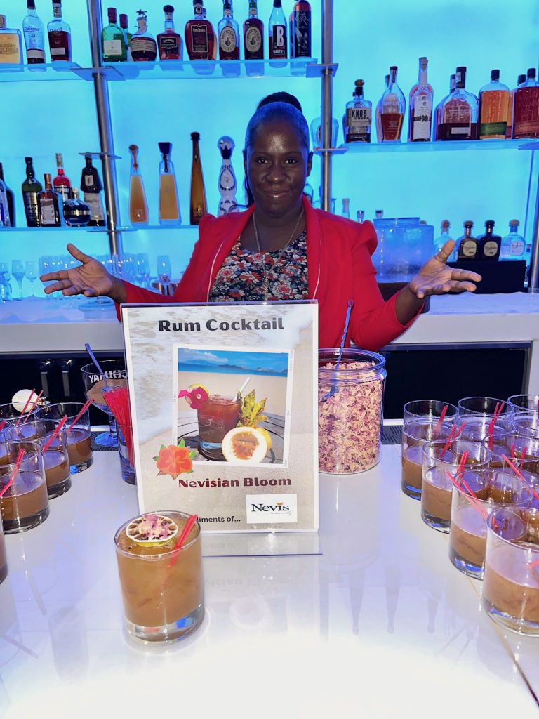 Ms. Kendie Williams, mixologist at the Four Seasons Resort, Nevis, with her rum cocktail creation “Nevisian Bloom” at “Brown Folks Connect” event at the Limani Restaurant at Rockefeller Plaza in Manhattan, New York on May 11, 2023