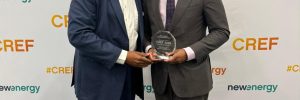 Premier and Minister of Energy in the Nevis Island Administration, the Honourable Mark Brantley (r) accepts the Caribbean Renewable Energy Forum Industry Award for Best Energy Resilience Project on behalf of Nevis at the 17th annual Caribbean Renewable Energy Forum in Miami